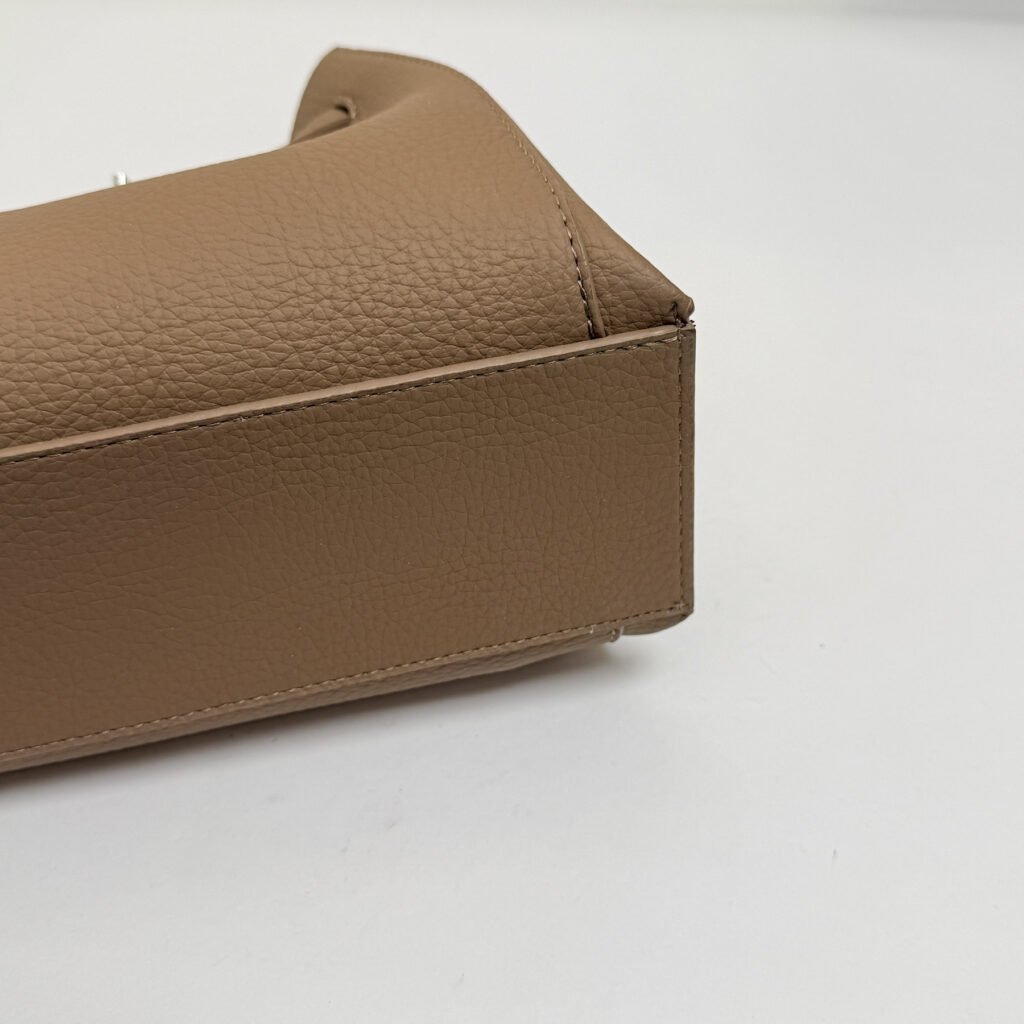 Bottom view of a taupe structured handbag