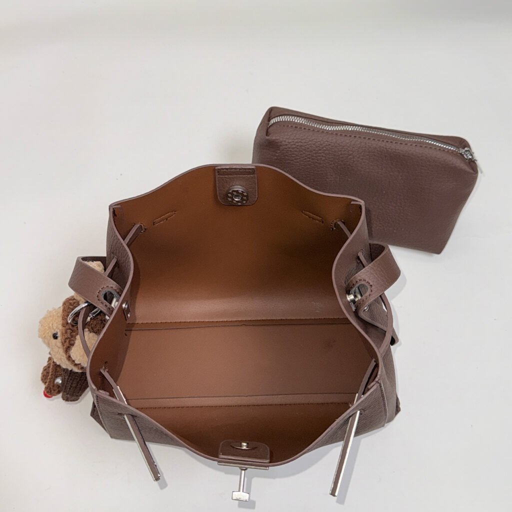 Open interior of a brown tote bag with matching pouch