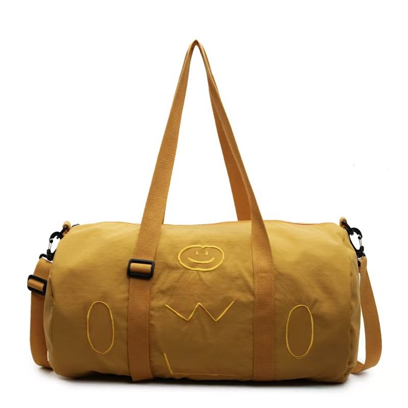 Yellow travel duffel bag with brown straps