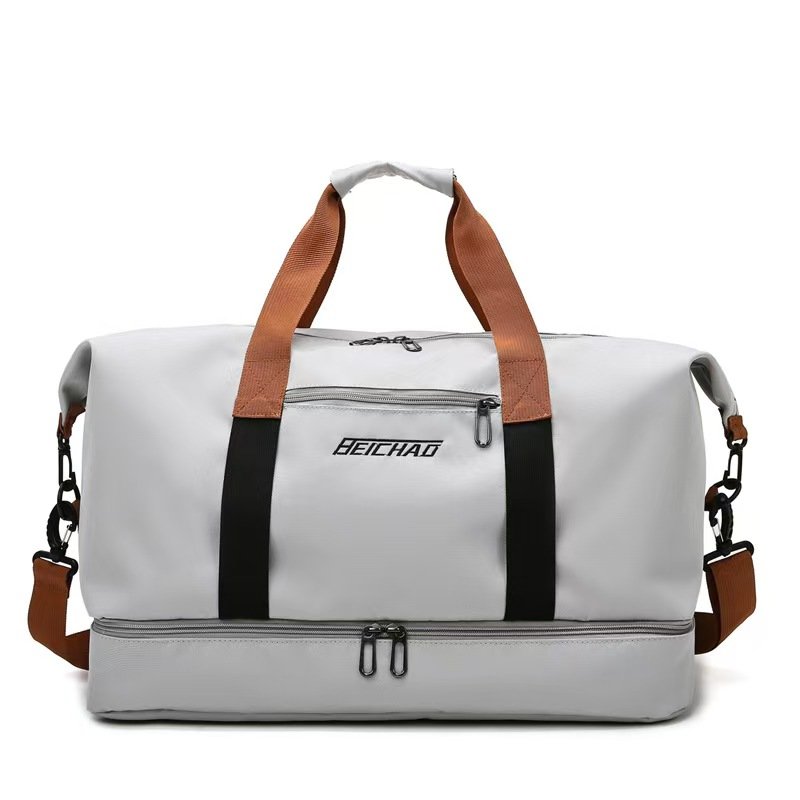 Light gray travel duffel bag with brown handles and lower zipper compartment