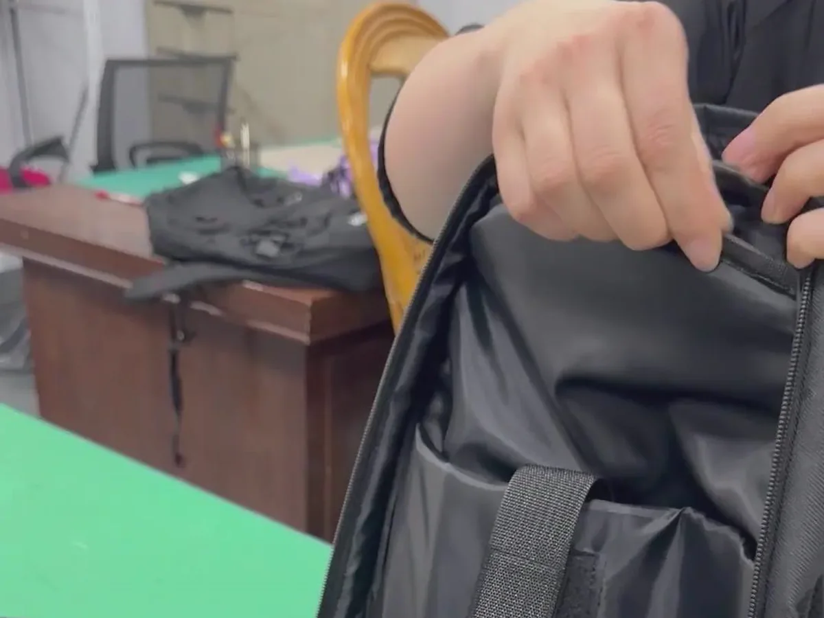 Backpack interior and strap reinforcement being visually checked