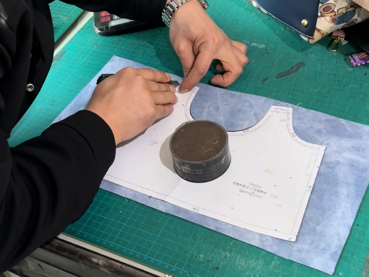 Bag pattern template being checked before cutting and assembly