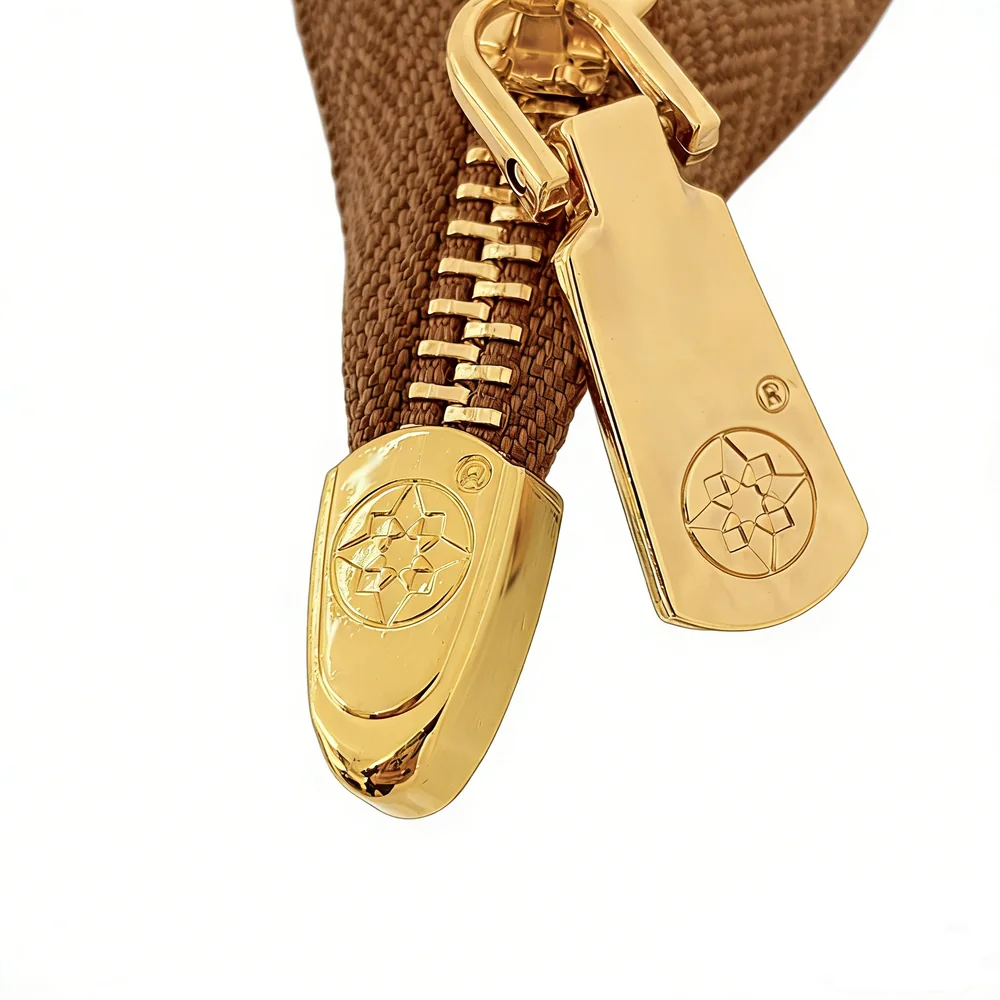Gold-tone custom zipper pull hardware detail