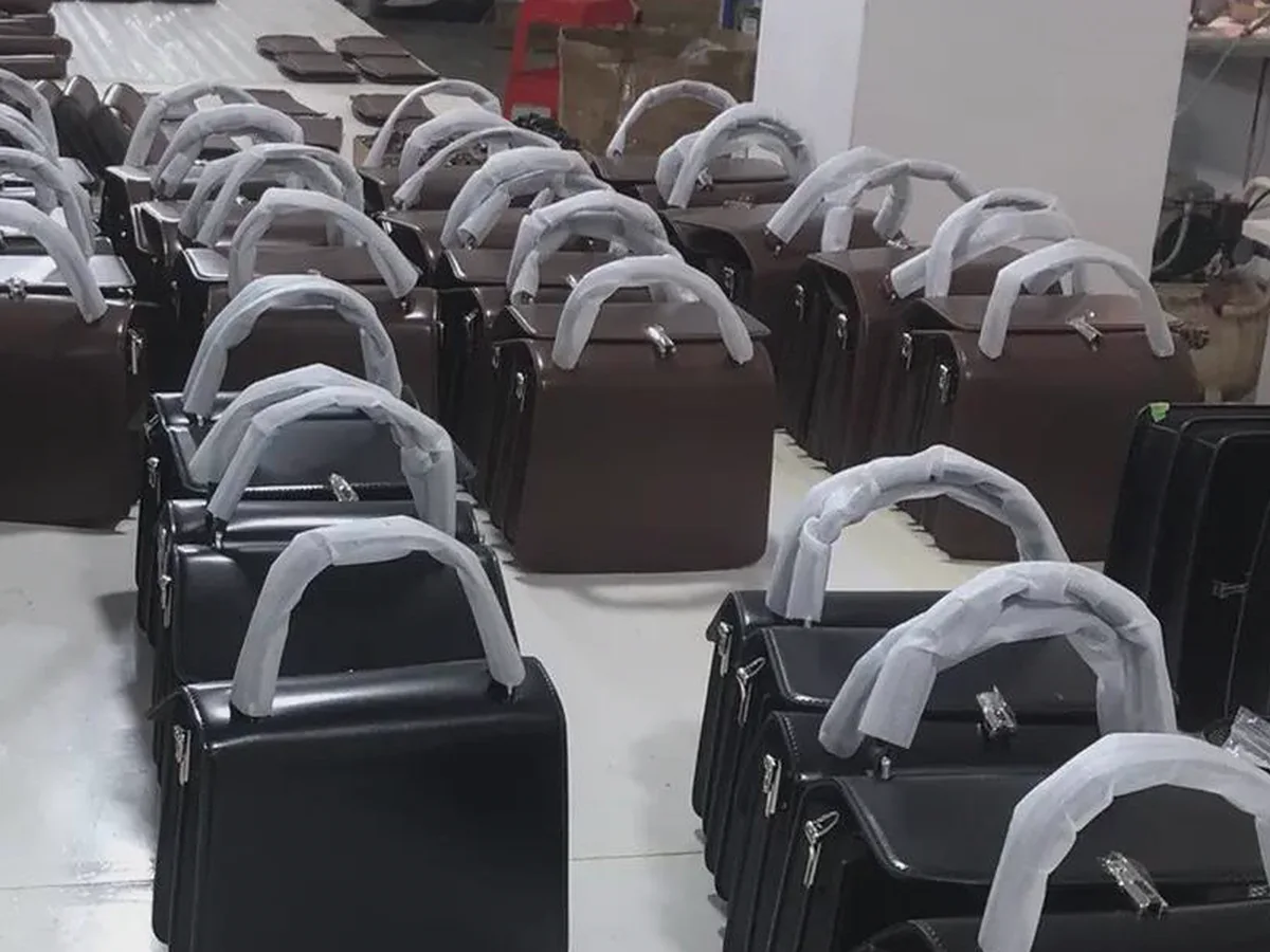 Finished bags being organized and reviewed at a production worktable
