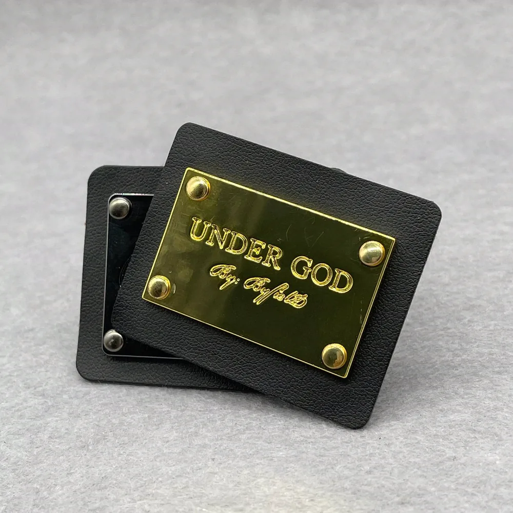Metal logo plates attached to black label samples