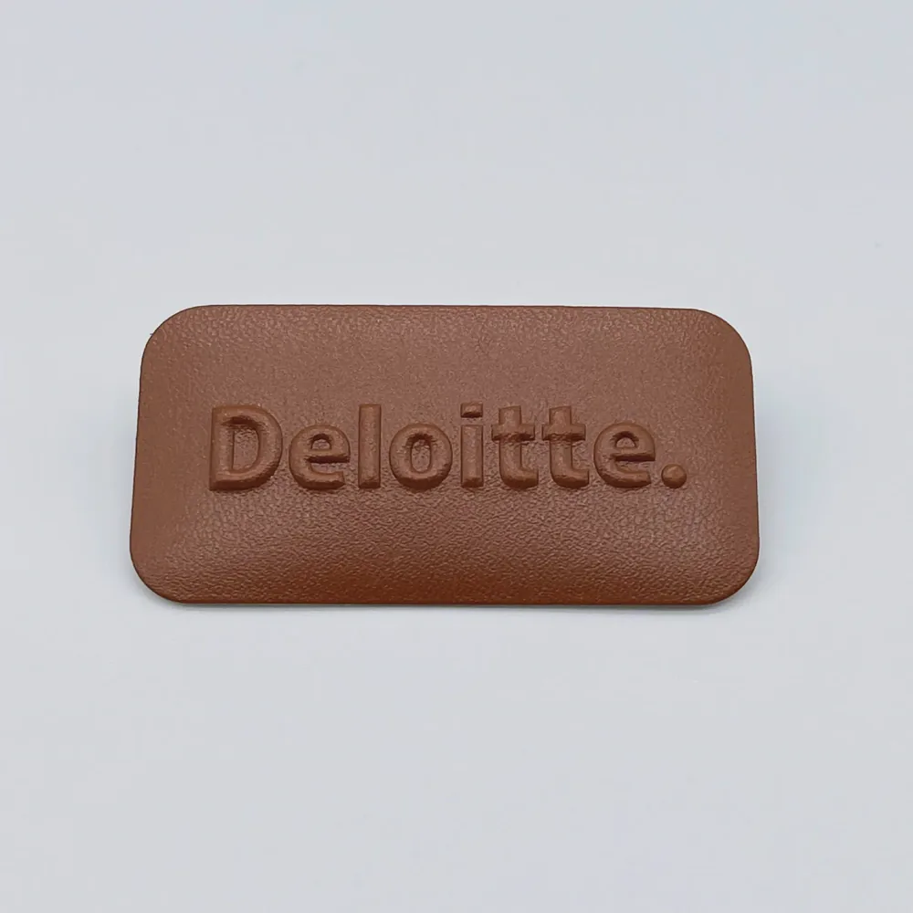 Brown label sample with a pressed logo detail