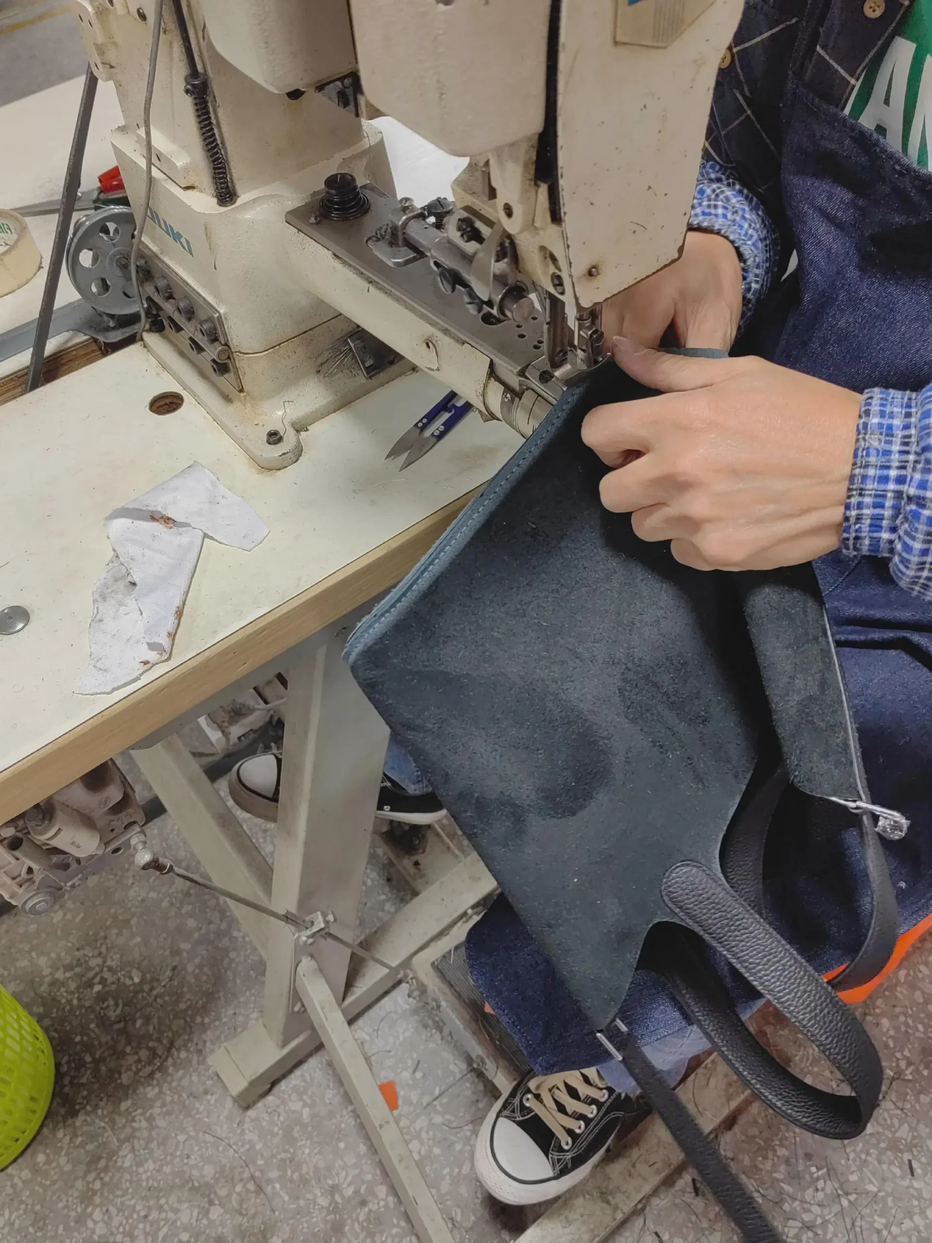 Bag panels being sewn during custom bag production