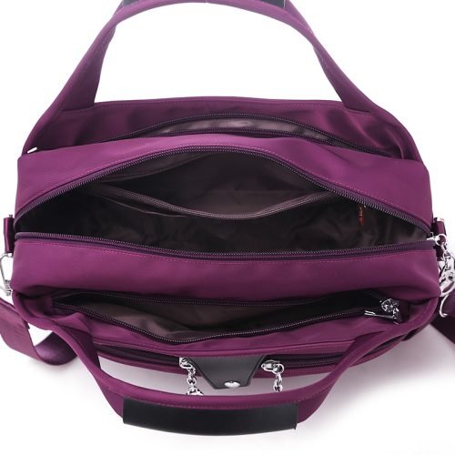 Open interior of a purple multi-pocket shoulder bag